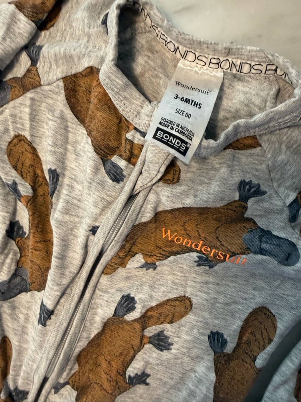 Bonds Wondersuit in gray with Brown Platypus Print - size 00/ 3-6 mo